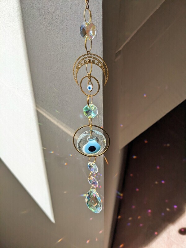 Attrape soleil fait main en pièce unique ou petite série, composé de matériaux durables de qualité.  Nazar en verre tout droit venu d&#39;Istanbul. Objet de décoration Feng Shui, l&#39;attrape soleil, invite à l&#39;intérieur de votre maison toutes les belles énergies du soleil en créant un arc-en-ciel lumineux plein de douceur et de magie. Il réharmonise et protège votre intérieur.