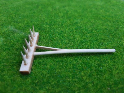 Kleiner Holzrechen 7,5 cm als Wichteltür Zubehör Miniatur-Holzrechen 7,5 cm auf grüner Grasmatte, naturfarben, handgefertigt, für Wichtel- und Feenwelten, Miniaturszenen.