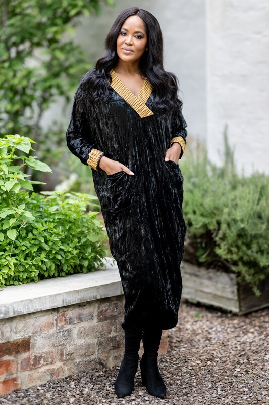 Front pockets Black dress with a trim detail