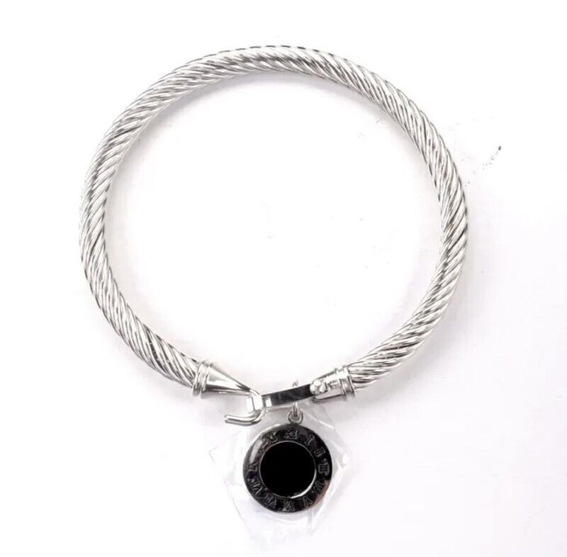 Silver bangle with black dial disc