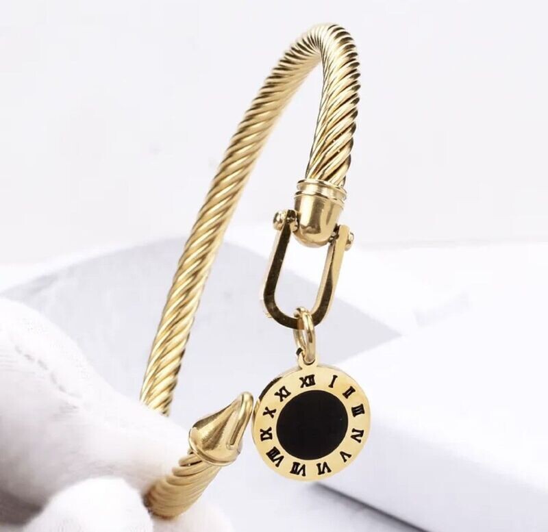 Gold bangle with black dial disc