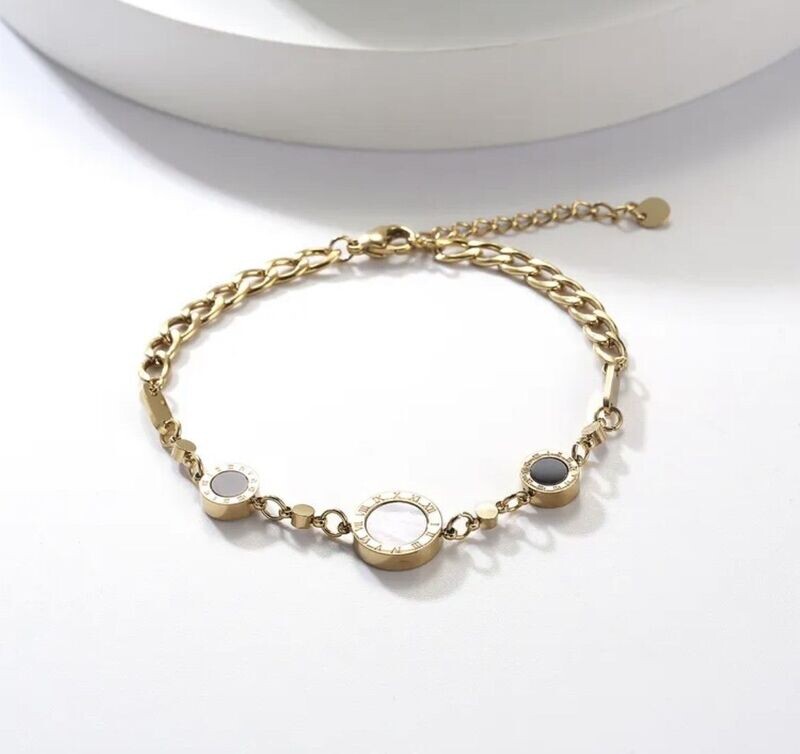 ​Gold chain bracelet with diamante dial disc and 2 black dial discs.