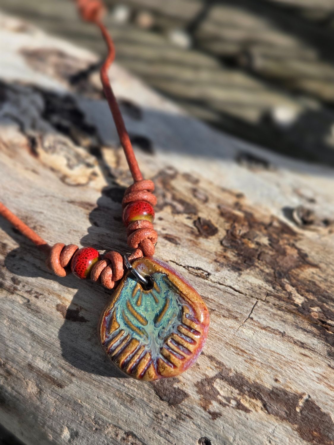 Ceramic pendant on leather cord