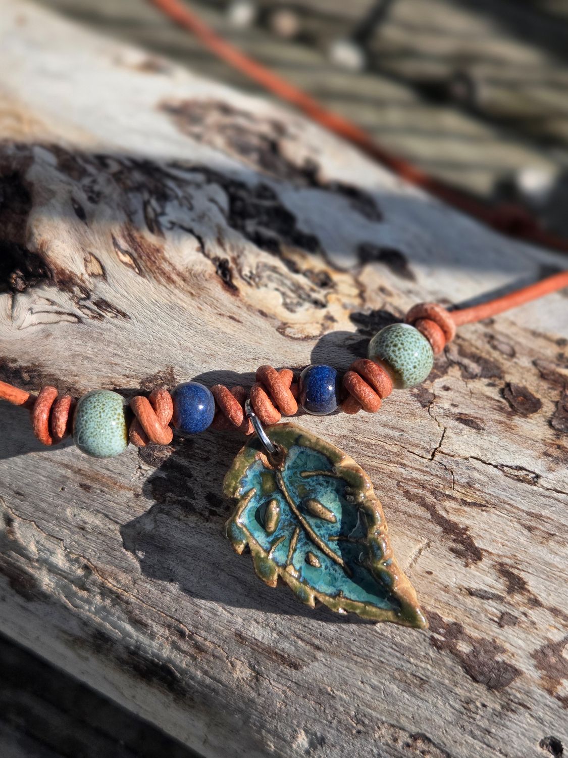 Ceramic pendant on leather cord