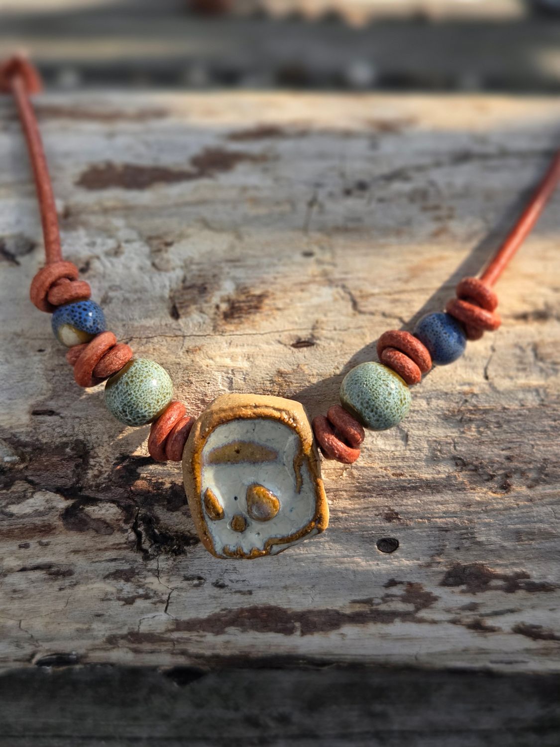 Ceramic pendant on leather cord