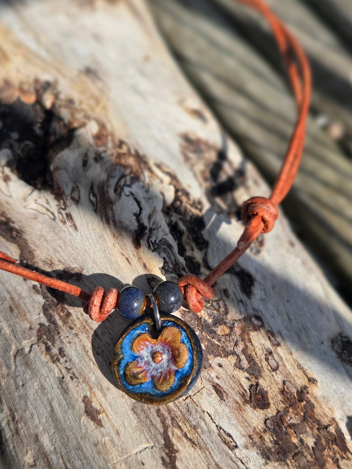 Ceramic pendant on leather cord