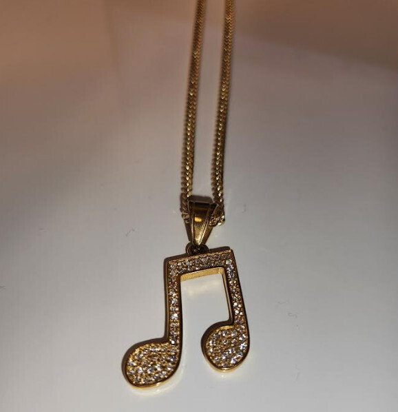 Gold diamond studded music note