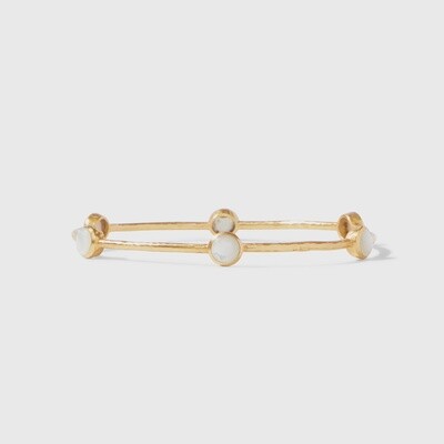 Julie Vos Milano bangle in 24k gold with hammered texture and embedded gemstones, photographed against a neutral studio background