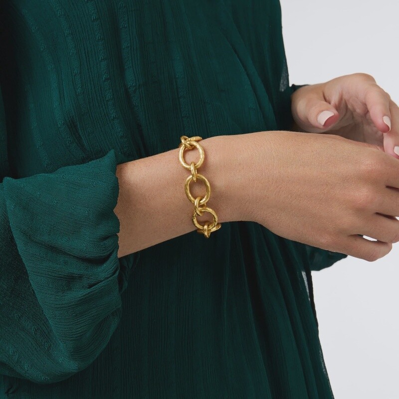Julie Vos Catalina Demi bracelet in 24K gold with hammered link design and toggle closure worn in a lifestyle setting