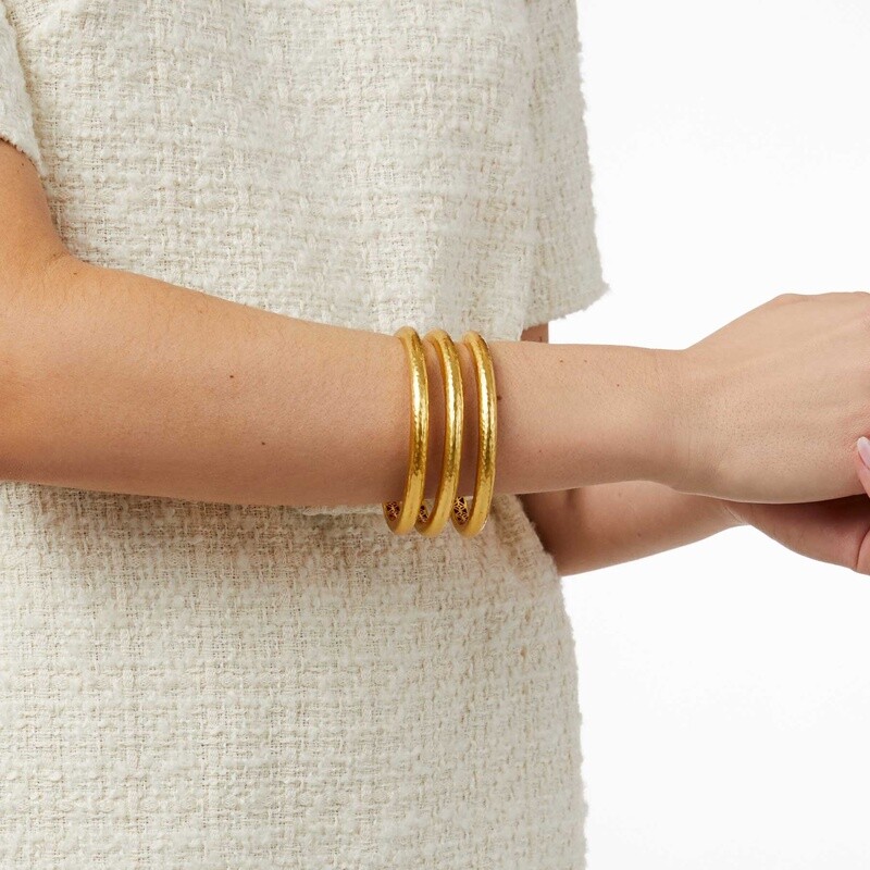 Julie Vos Havana gold bangle with 24K gold plate and hammered piercework detail worn in a lifestyle setting