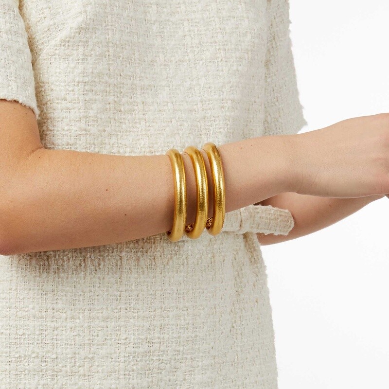 Julie Vos Havana bangle in 24K gold-plate with hand-hammered texture worn on wrist in lifestyle setting