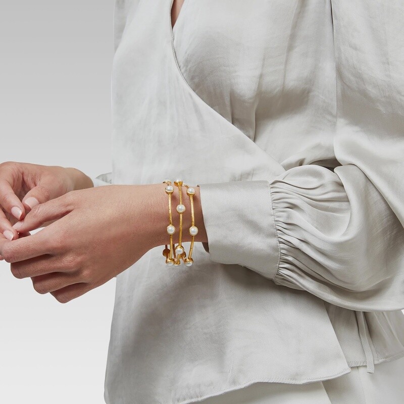 Julie Vos Milano Luxe bangle in hammered 24K gold with iridescent pavé detailing worn on wrist in lifestyle setting