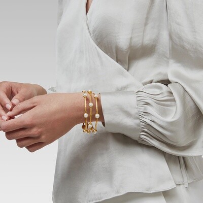 Julie Vos Milano Luxe bangle in hammered 24K gold with iridescent pavé detailing worn on wrist in lifestyle setting