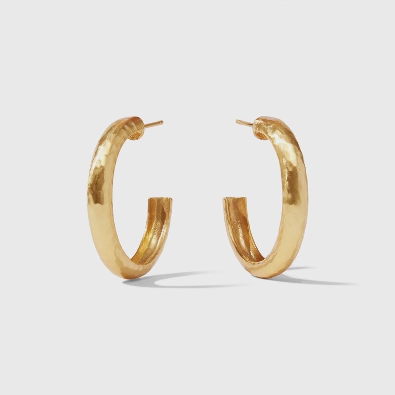 Julie Vos Havana hand-hammered hoop earrings in 24K gold plate, worn in a lifestyle setting