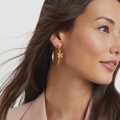 Gold-plated butterfly hoop earrings with beaded edge detail worn in a lifestyle setting
