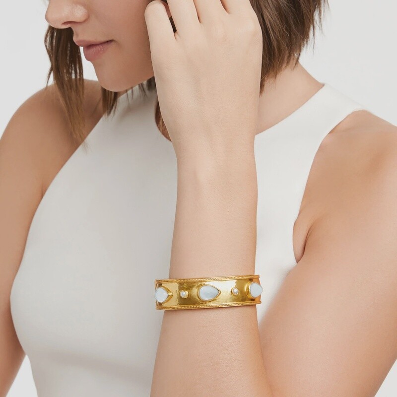 Julie Vos Cannes wide hinge bangle in 24K gold with a faceted pear-shaped gemstone, shown on wrist in lifestyle setting