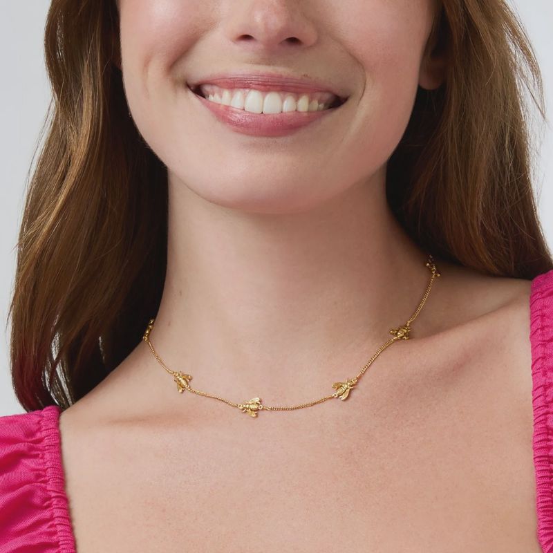Julie Vos Bee Station Necklace in 24K gold plate, adjustable 16.5–17.5 inches, worn in a lifestyle setting