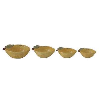 Set of stoneware measuring cups shaped like lemons in cream and yellow tones, arranged on a neutral background