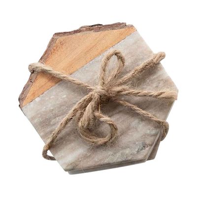 Set of four hexagon coasters in white marble and natural acacia wood with bark edge detailing, arranged on a neutral studio background.