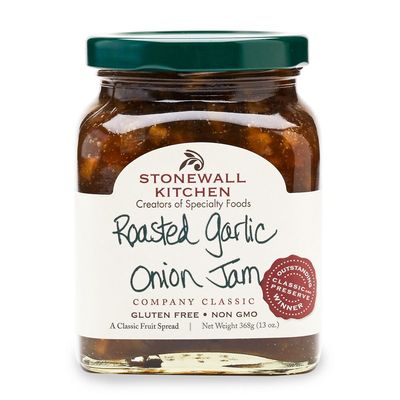 Stonewall Kitchen roasted garlic onion jam with balsamic vinegar in a glass jar against a neutral studio background