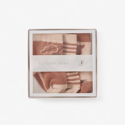 Three pairs of non-slip baby socks in animal print patterns, sizes 0-12 months, displayed on white background