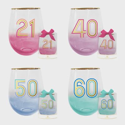 Two clear glass wine glasses with colorful birthday milestone numbers printed on them, displayed against a white background
