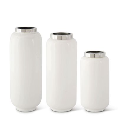 White enameled vase with silver rim detail, displayed against a neutral background in studio lighting