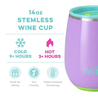 Ultra violet stemless wine cup holding red wine on an outdoor patio table with blurred background
