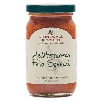 Stonewall Kitchen Mediterranean feta spread with roasted red peppers in a glass jar on white background