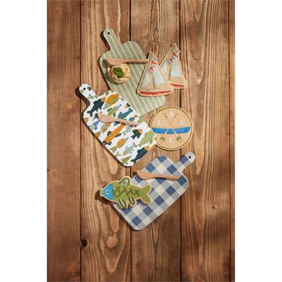 Mud Pie Lake melamine paddle board and napkin three-piece set arranged on an outdoor table with natural lighting