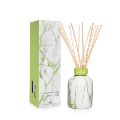 Capri Blue Honeydew Crush petite reed diffuser with marble base and reeds on white background