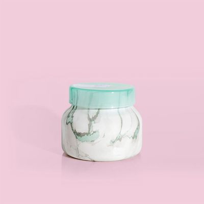 Capri Blue Coconut Santal candle in a modern marble petite jar, 8 oz, displayed in a lifestyle setting