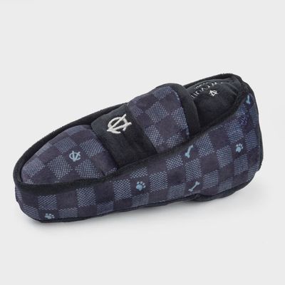 Black and white checkered plush dog loafer toy with quilted texture detail, isolated on white background