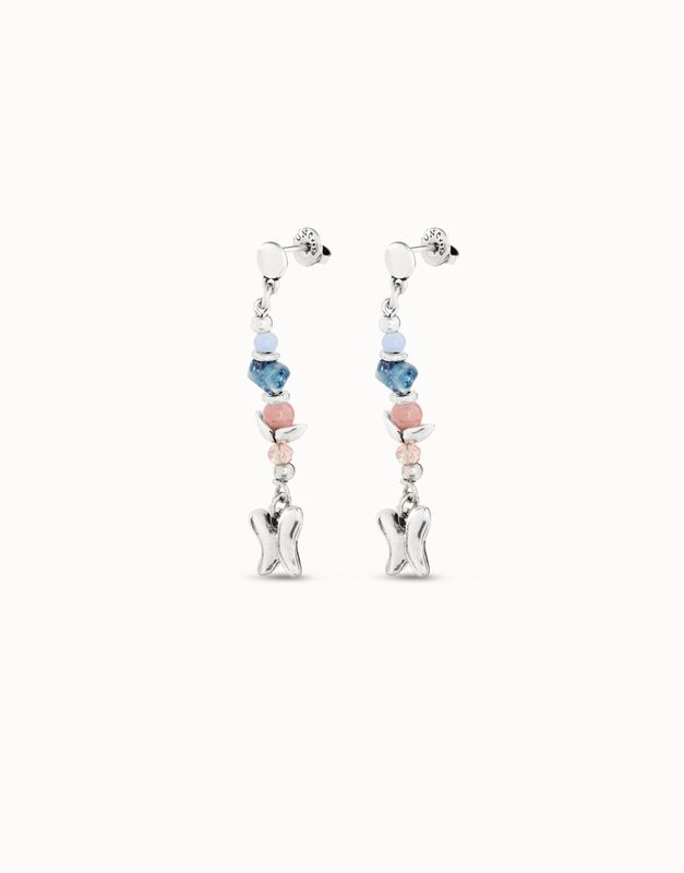 Uno de 50 Metamorphosis butterfly crystal drop earrings worn in a lifestyle setting, showcasing the delicate crystal pendant details