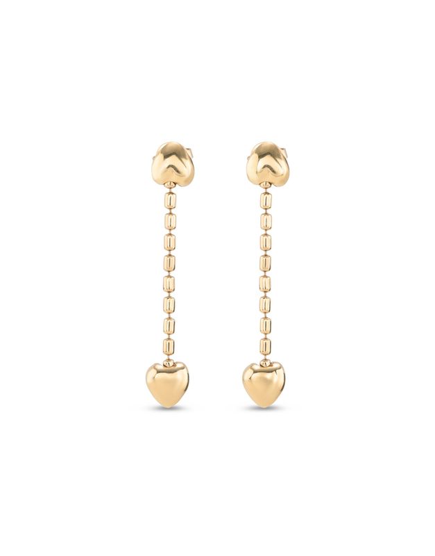 Uno de 50 Cupido heart earrings displayed in a lifestyle setting, showing the ornamental heart-shaped design with metallic detailing