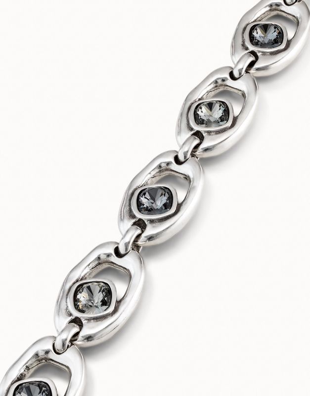 Uno de 50 Together bracelet with oval crystal bead and carabiner clasp worn on wrist in lifestyle setting