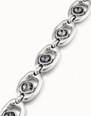 Uno de 50 Together bracelet with oval crystal bead and carabiner clasp worn on wrist in lifestyle setting