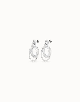 Silver-plated triple hoop earrings from Uno de 50 worn on a model, showing the layered hoop design and metallic finish.