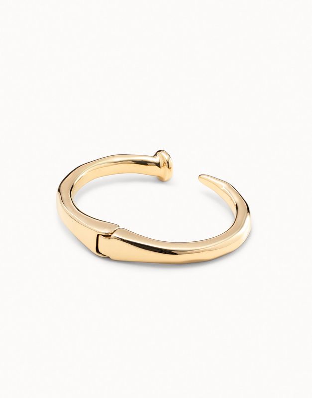 Silver-plated rigid bracelet with nail-shaped design worn on wrist in lifestyle setting