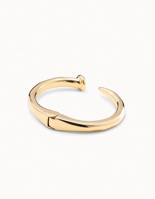 Silver-plated rigid bracelet with nail-shaped design worn on wrist in lifestyle setting