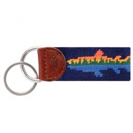 Smathers and Branson lake trout needlepoint key fob in shades of blue and green with tan leather backing, displayed against a white background