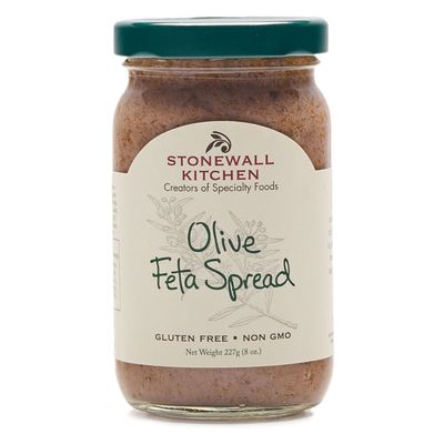 Stonewall Kitchen Olive Feta Spread with Garlic in a glass jar displayed against a neutral studio background