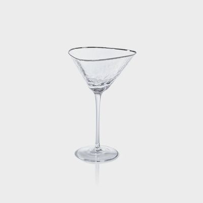 Zodax Aperitivo triangular martini glass filled with a clear cocktail, displayed in a styled table setting