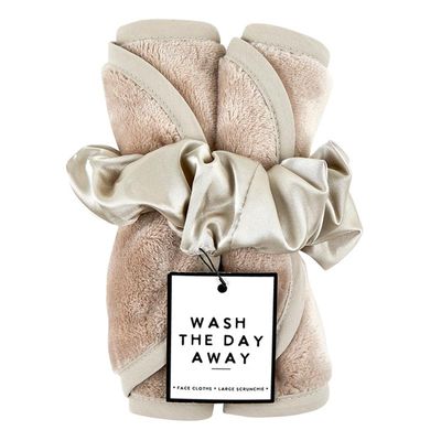 Reusable exfoliating face cloth set with matching scrunchie arranged on a neutral surface, showing the textured fabric weave.