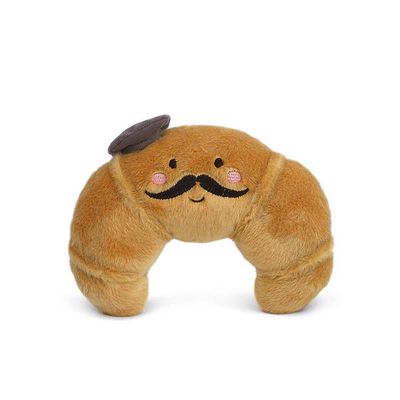 Mon Ami Monsieur Croissant plush stuffed animal toy in golden brown croissant shape with embroidered details, 7 inches tall, displayed against white background