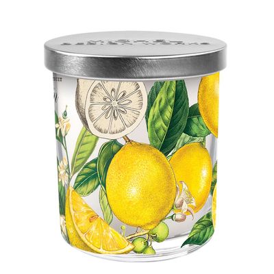 Michel Design Works lemon basil soy blend candle in a clear decorative glass jar with label, shown against a white background