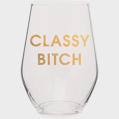 Clear wine glass with gold foil lettering reading Classy Bitch, shown against a white studio background