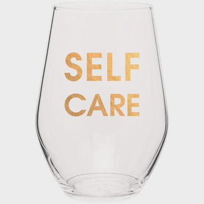 Gold foil stemless wine glass by Chez Gagne against a neutral background, showing decorative metallic detailing on clear glass
