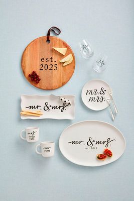 Hand-painted stoneware platter with Mr &amp; Mrs Est 2025 text in a lifestyle table setting with natural lighting