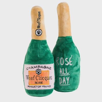 Woof Clicquot Rosé plush squeaker dog toy by Haute Diggity Dog, champagne bottle-shaped design with pink fabric and metallic gold accents on white background